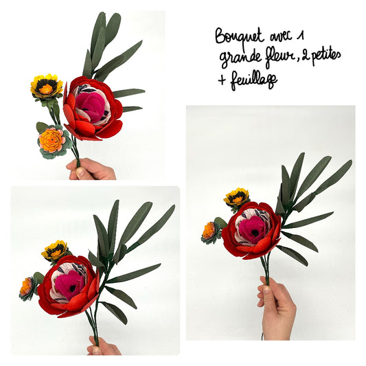 Bouquet de trois fleurs en papier avec feuillage. La fleur principale est rouge.