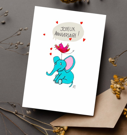 Carte d'anniversaire représentant un éléphant bleu avec un petit oiseau rose sur sa tête. Idéale pour un enfant