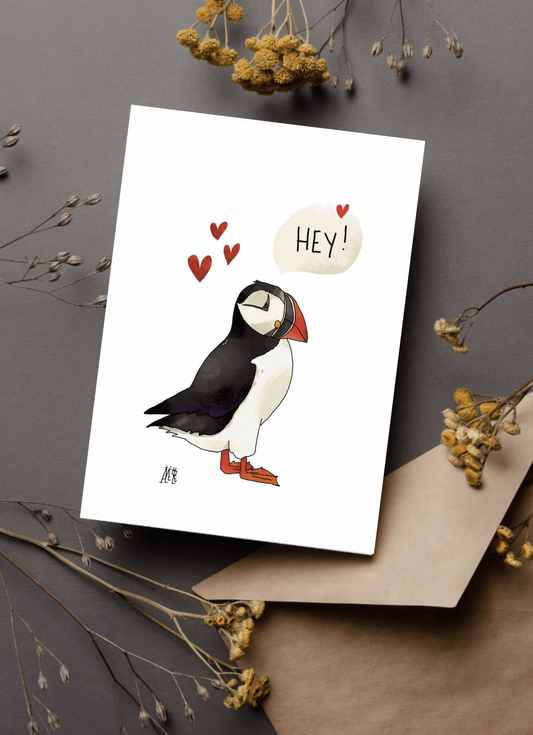 Carte postale de format A6 (Classique) Un macareux de profil. Avec des coeurs autour et une bulle au-dessus : "Hey!"
